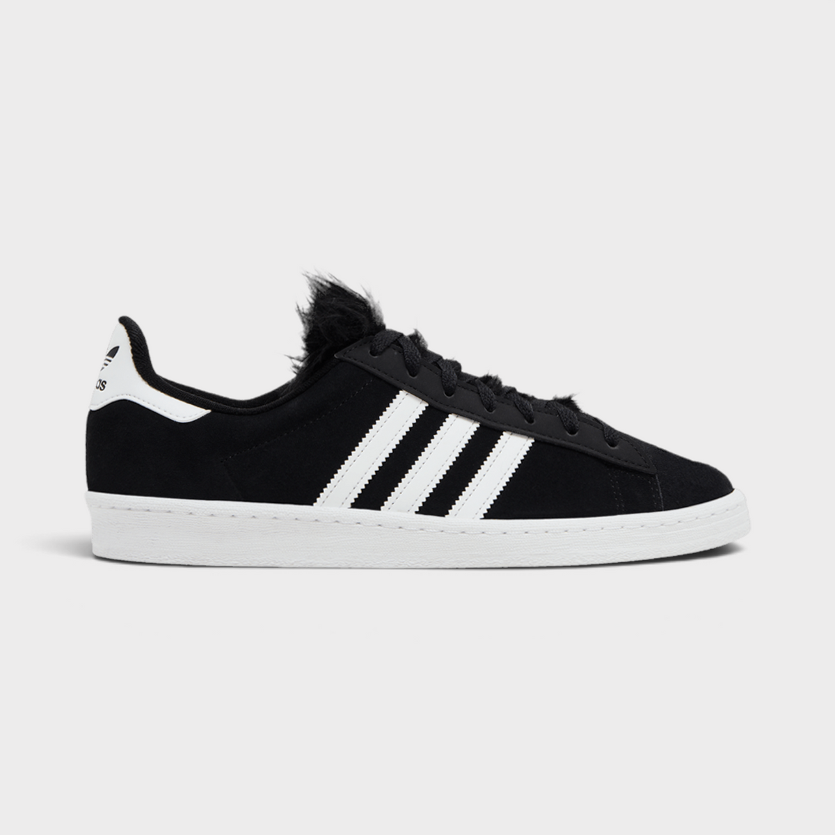 Supplied Fashion Jeremy Scott Campus 80 black suede trainers with white stripes and unique faux fur tongue detail