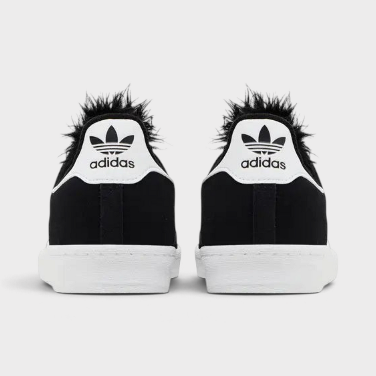 Supplied Fashion Jeremy Scott Campus 80 trainers in black and white with signature faux fur heel detail, rear view.
