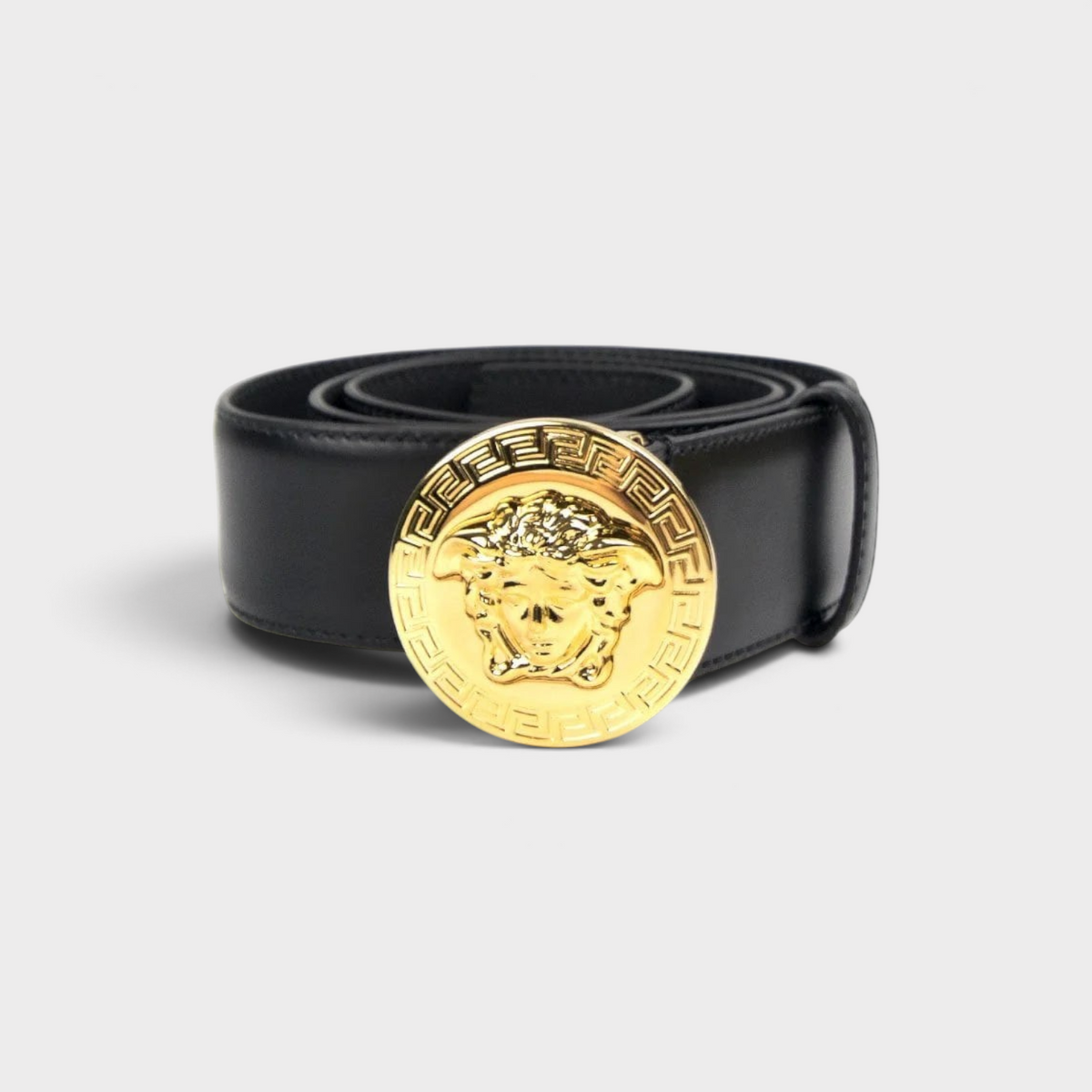 Supplied Fashion black leather belt with a round gold Medusa head buckle featuring Greek key detailing.