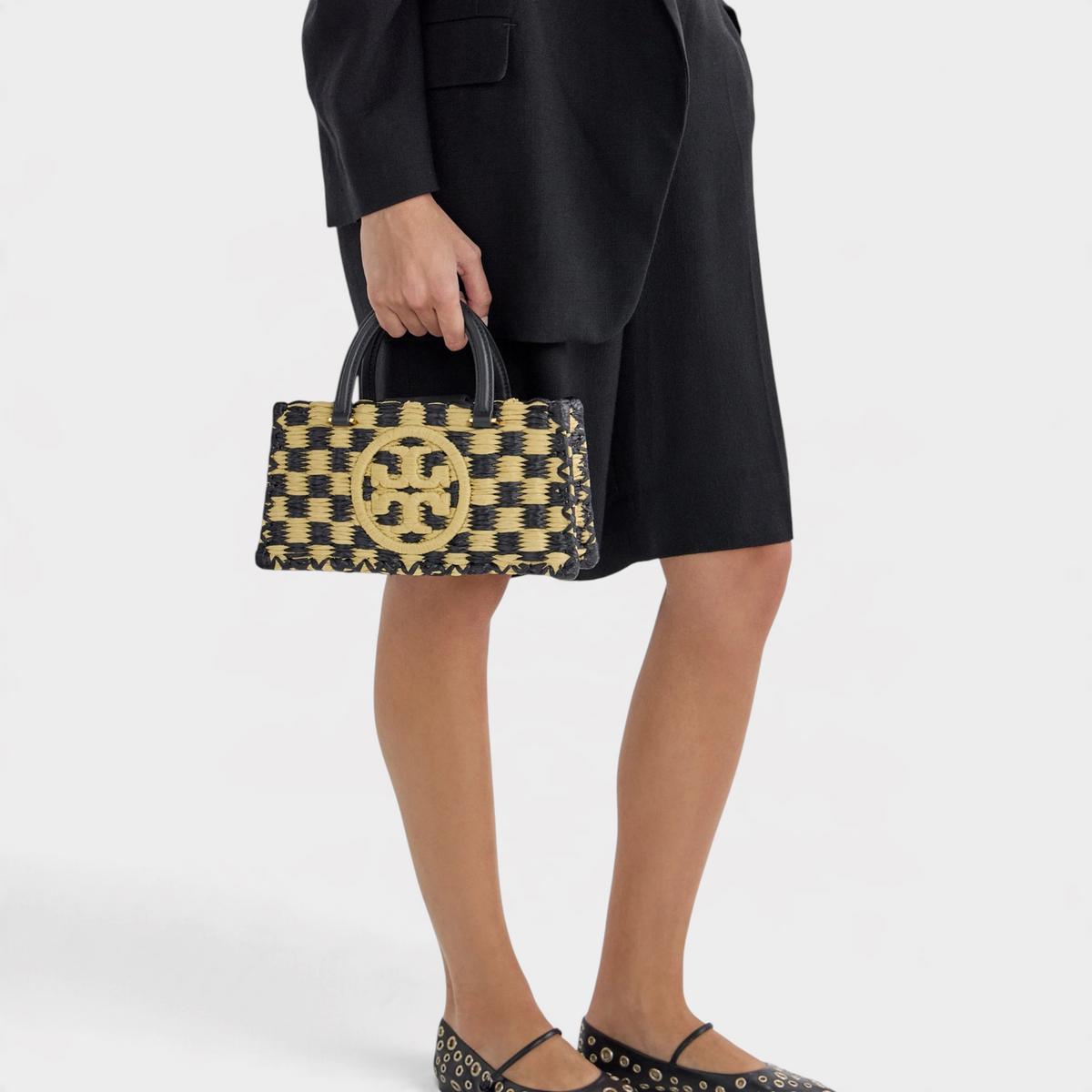 Supplied Fashion Ella hand-crocheted checkered handbag in black and natural straw with a gold logo emblem