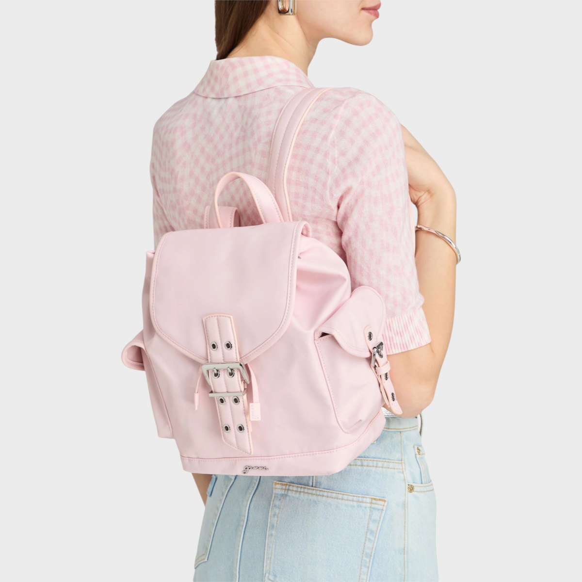 Supplied Fashion Ganni Bucky shell backpack in chalk pink with buckle closure worn on a model