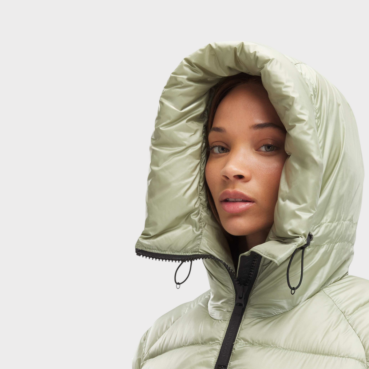 Supplied Fashion Canada Goose Cypress puffer jacket in cedar green with a protective hood on a model