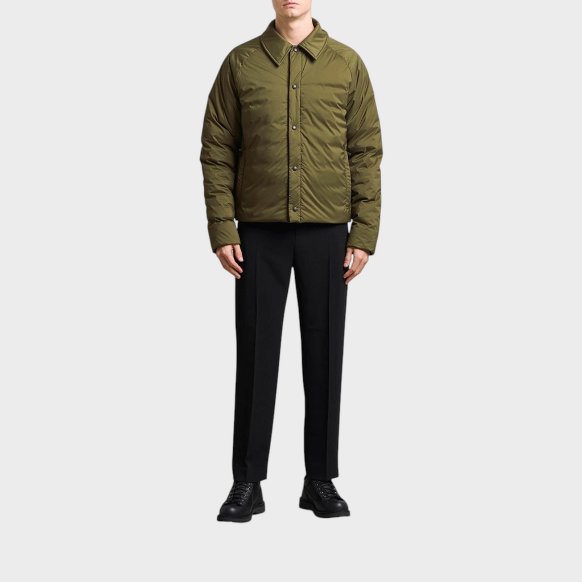 Supplied Fashion military green Lodge coach jacket worn by a man with black trousers and boots