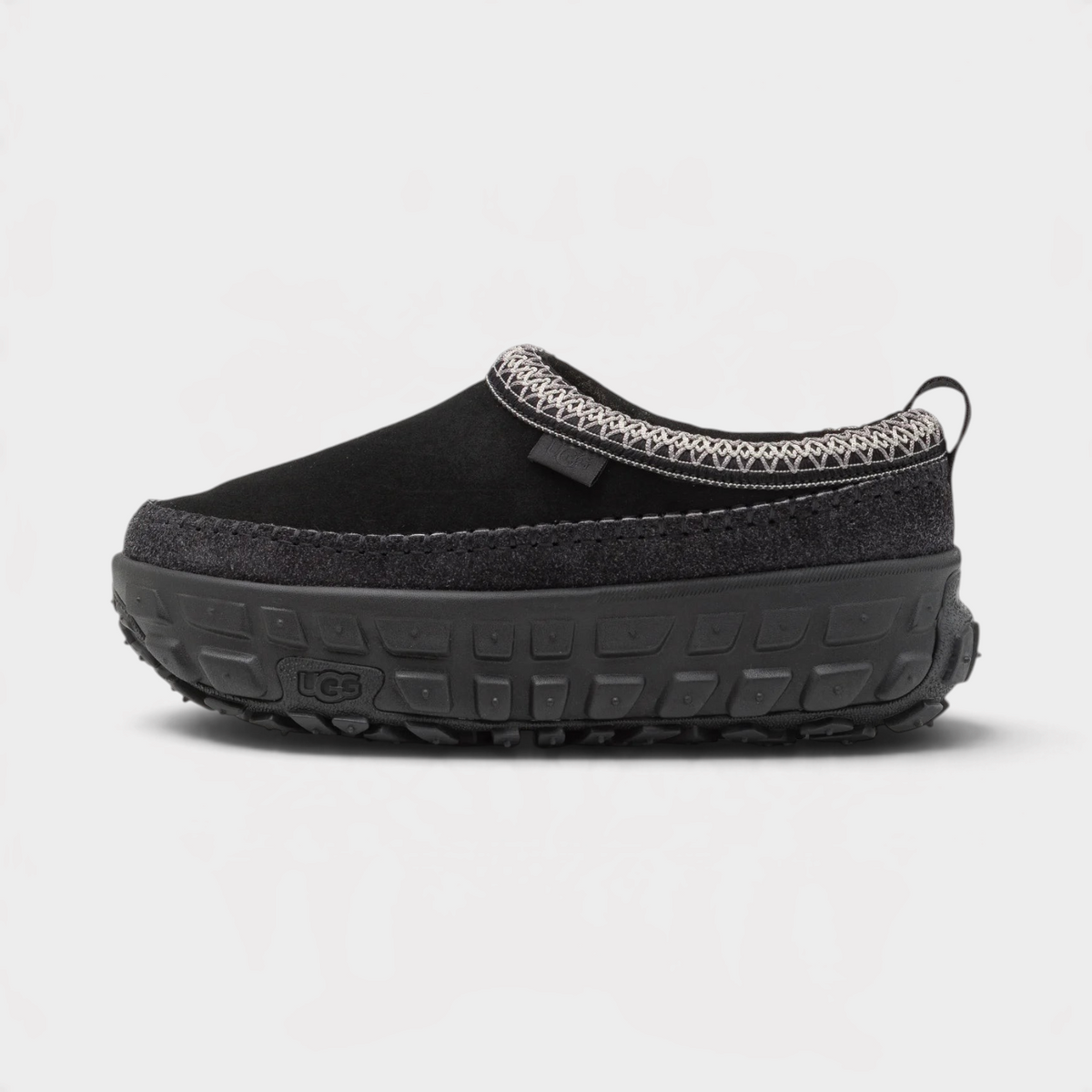 Supplied Fashion Venture Daze black slip-on shoe with a thick textured platform sole and patterned collar trim.
