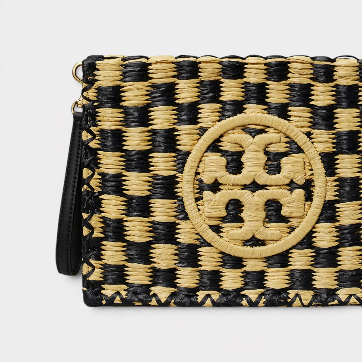 Supplied Fashion Ella crochet raffia pouch in a black and beige woven checkerboard pattern with a central logo detail.