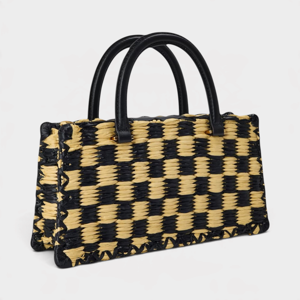 Supplied Fashion Ella hand-crocheted checkered handbag in black and natural straw with black leather handles.