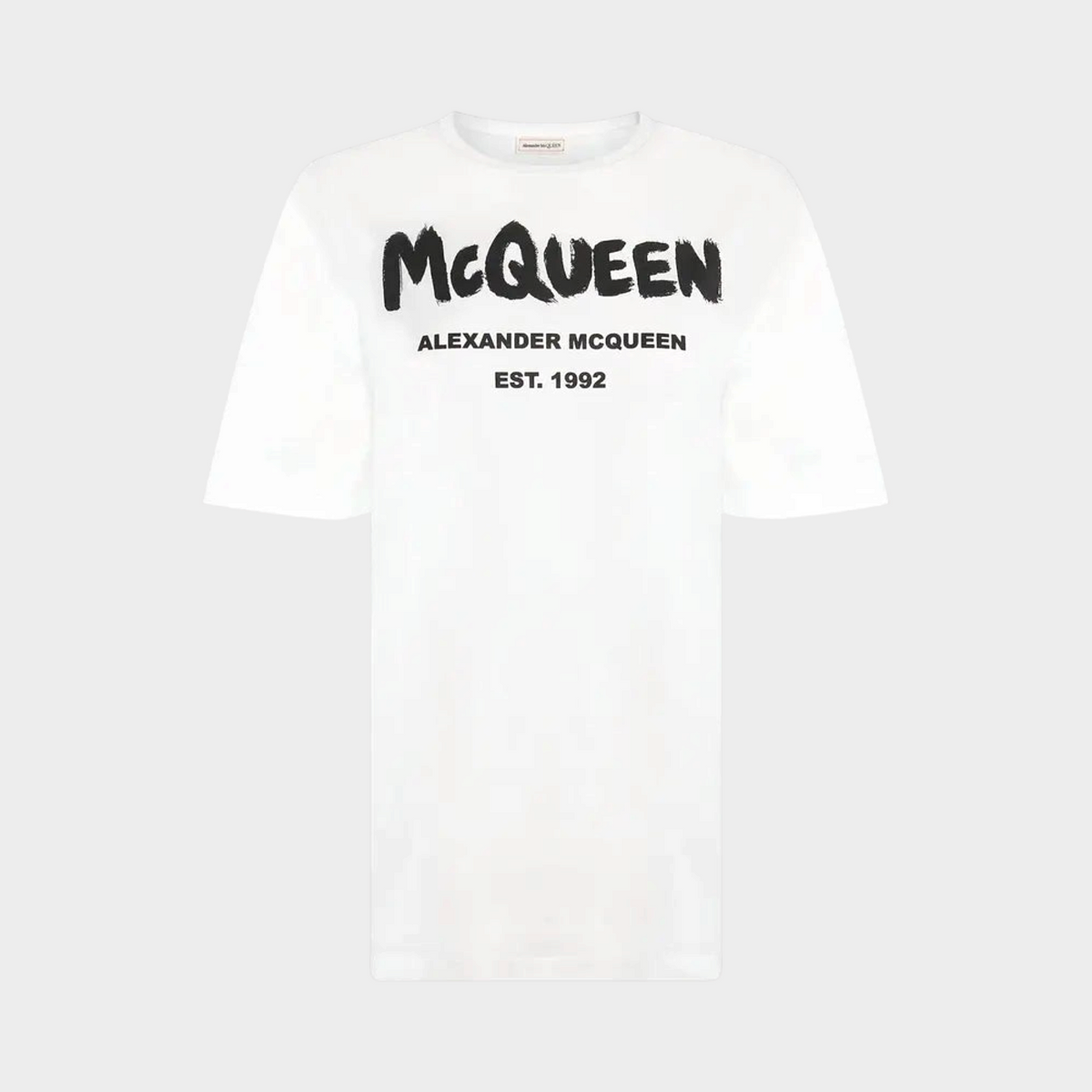Supplied Fashion white cotton t-shirt featuring a bold black Alexander McQueen graffiti logo print on the chest.