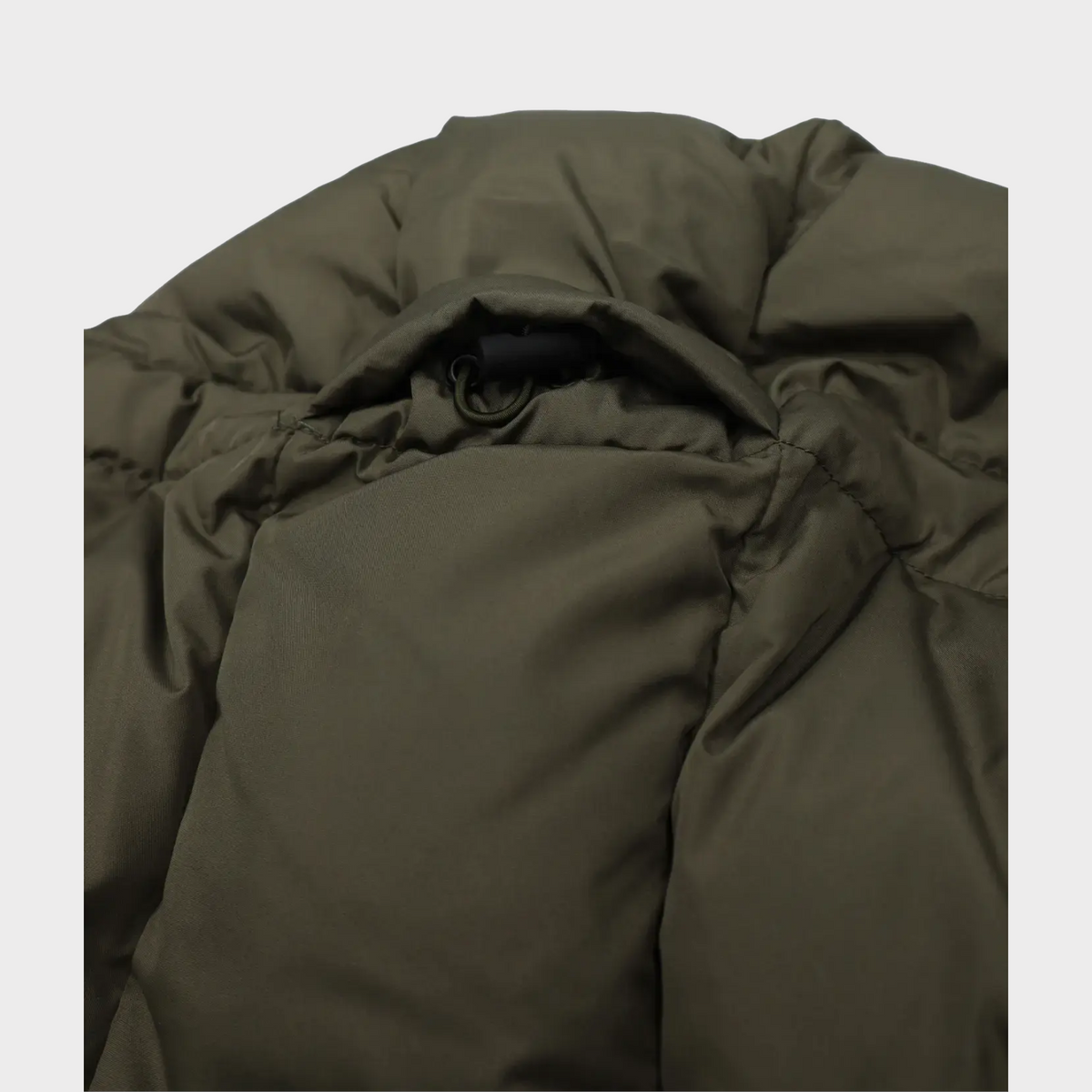Supplied Fashion green down puffer jacket featuring a close-up of the adjustable hood drawstring and quilted texture.