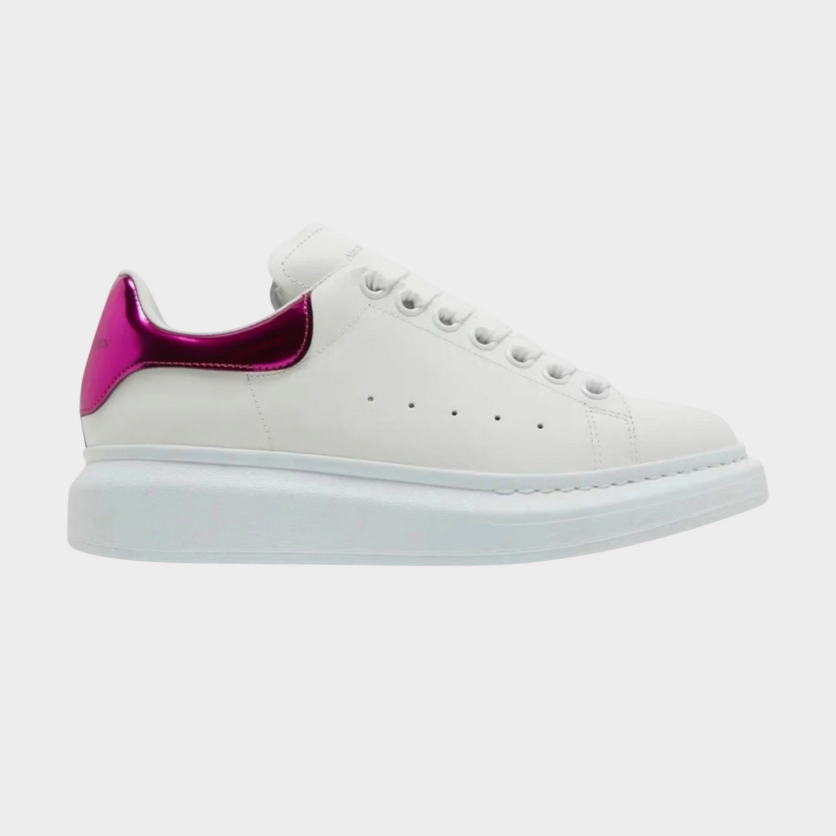 Supplied Fashion kids oversized white sneaker with a metallic pink heel tab and thick platform sole.