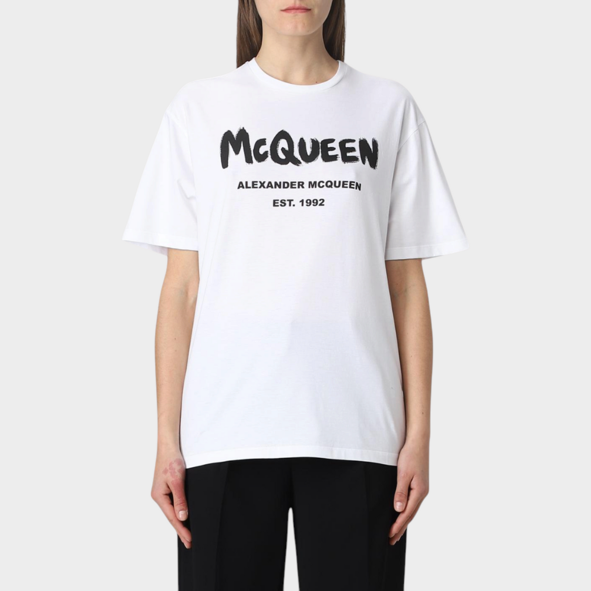 Supplied Fashion white cotton t-shirt featuring a black Alexander McQueen graffiti logo print on the chest.