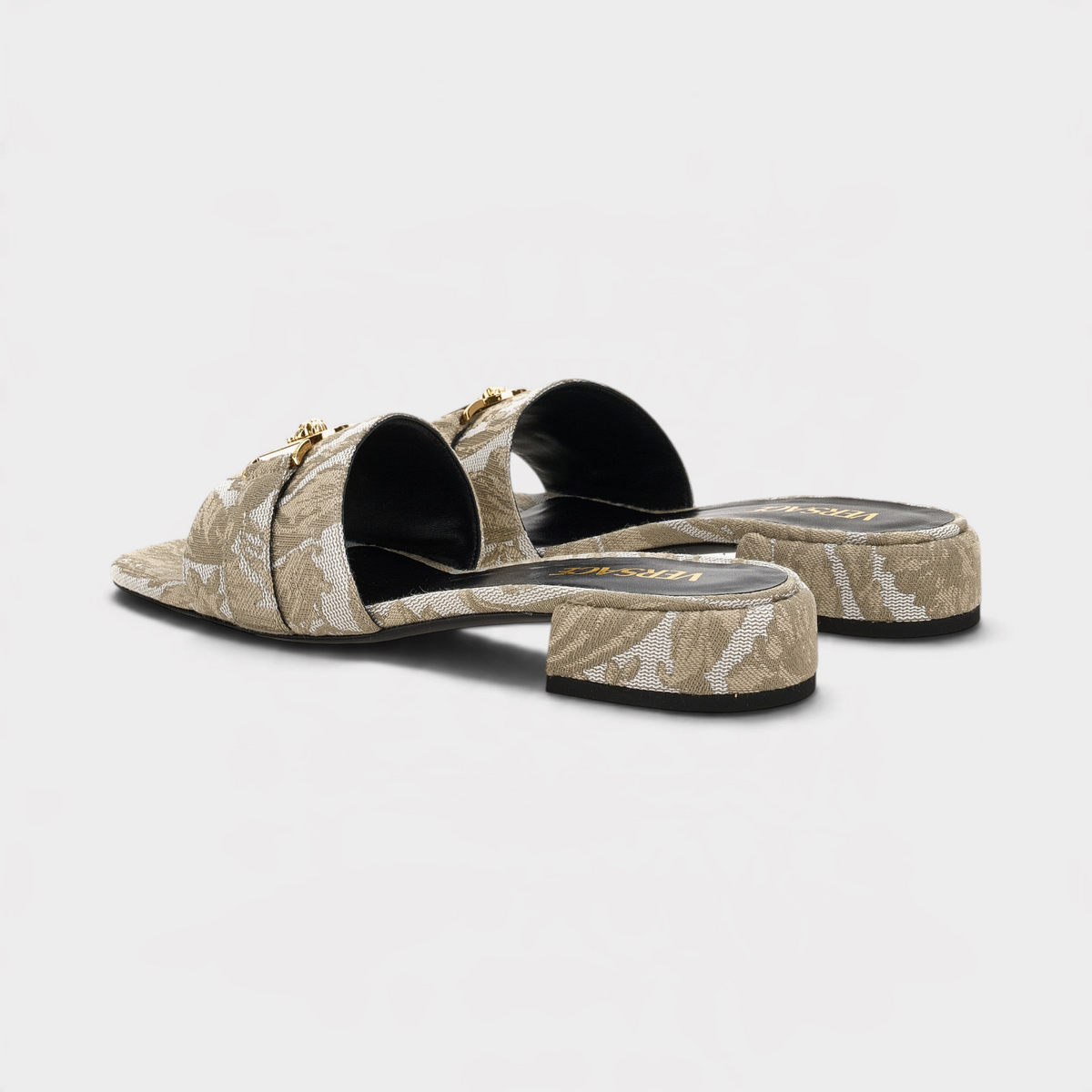 Supplied Fashion beige fabric sandals featuring the iconic Versace Medusa head emblem and a low block heel.