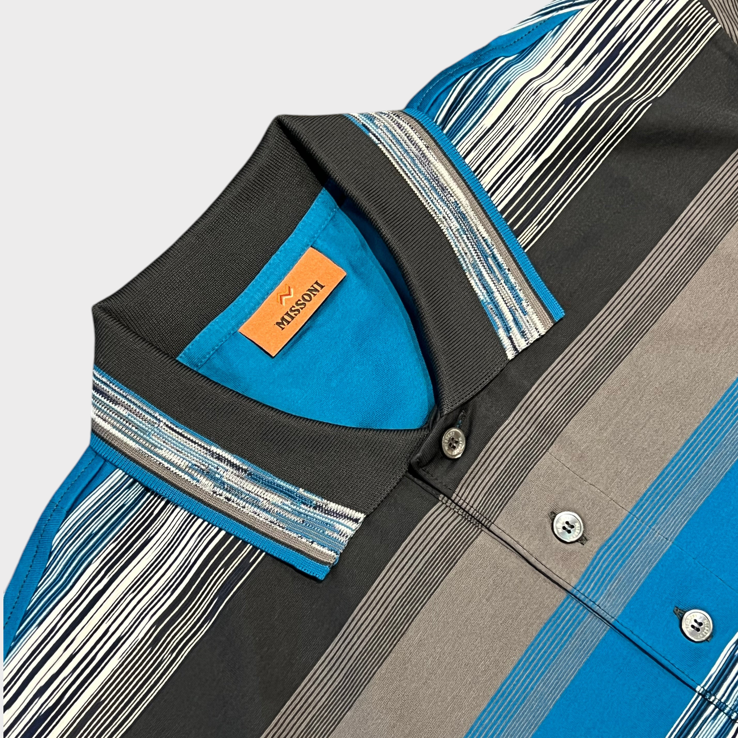 Supplied Fashion Missoni short sleeve polo shirt in blue, grey, and white striped knit with a classic collar
