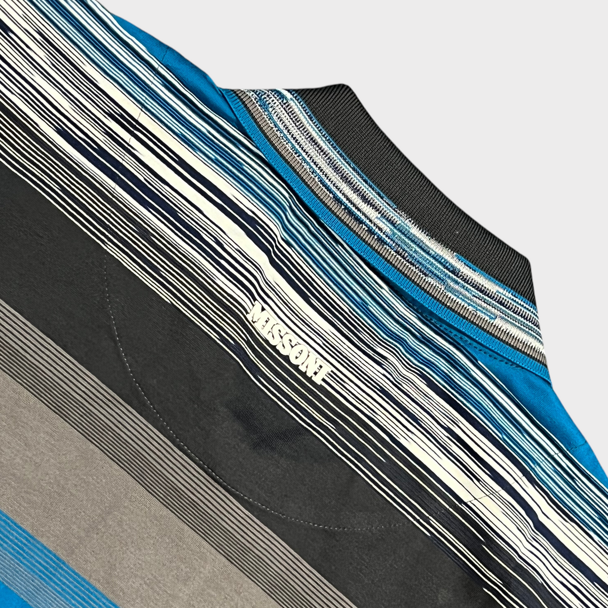 Supplied Fashion Missoni short sleeve polo shirt featuring a blue and grey striped knit pattern and ribbed collar.