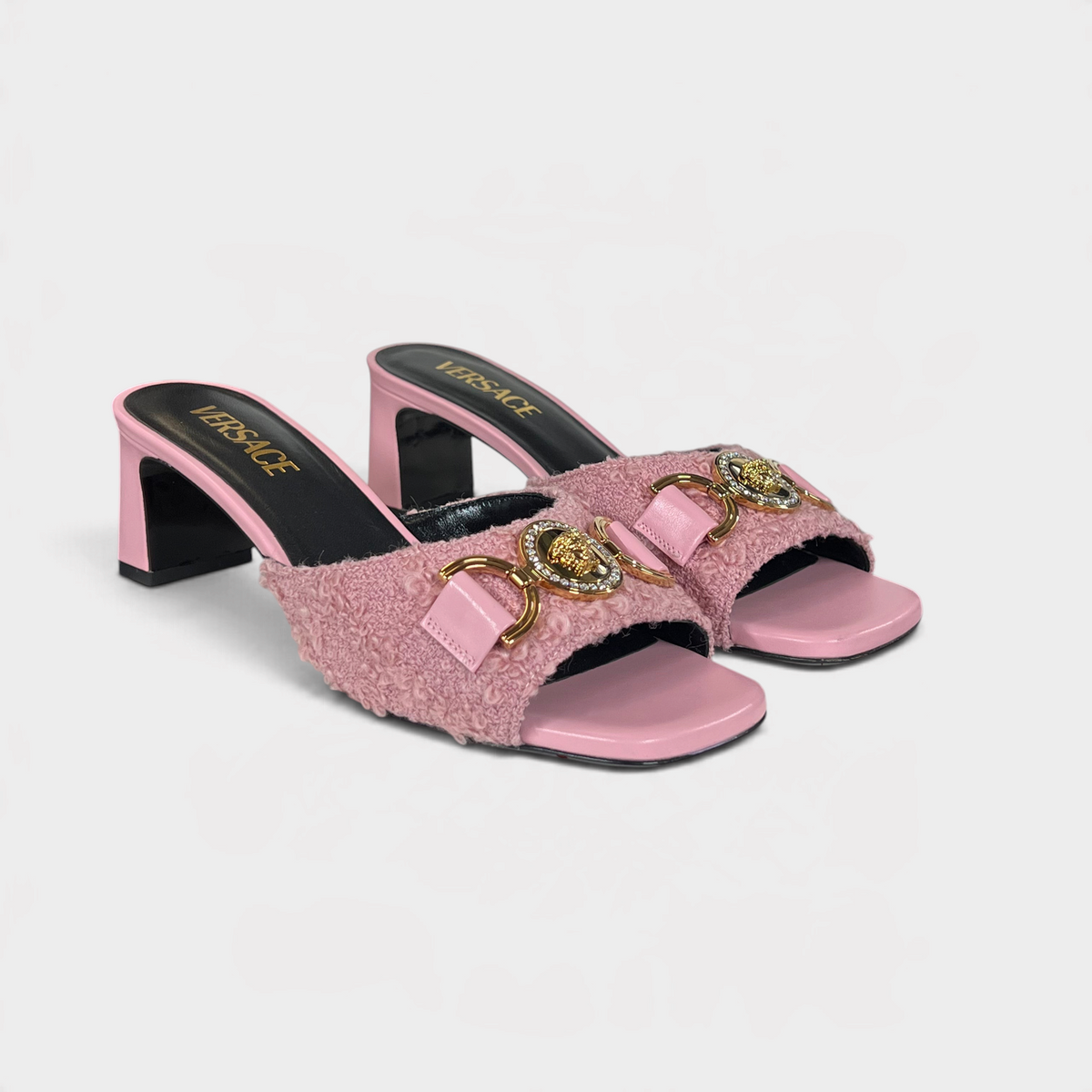 Supplied Fashion pink tweed mules featuring a gold Medusa head emblem and a block heel for a luxurious look.