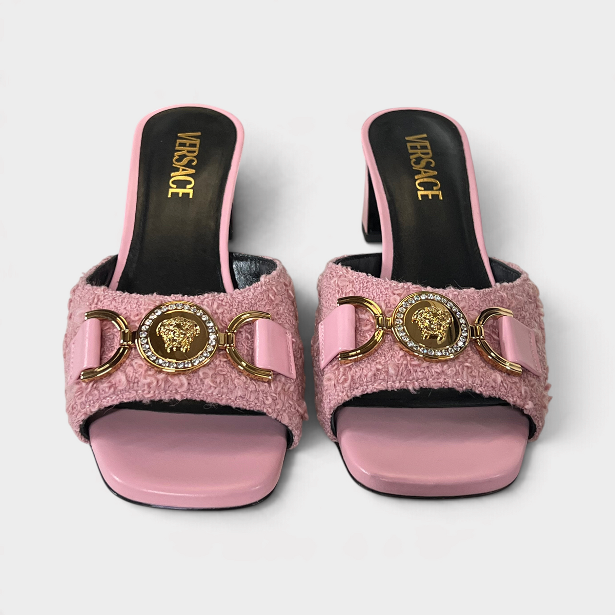 Supplied Fashion pink tweed Versace mules featuring a gold Medusa head emblem and crystal embellishments.