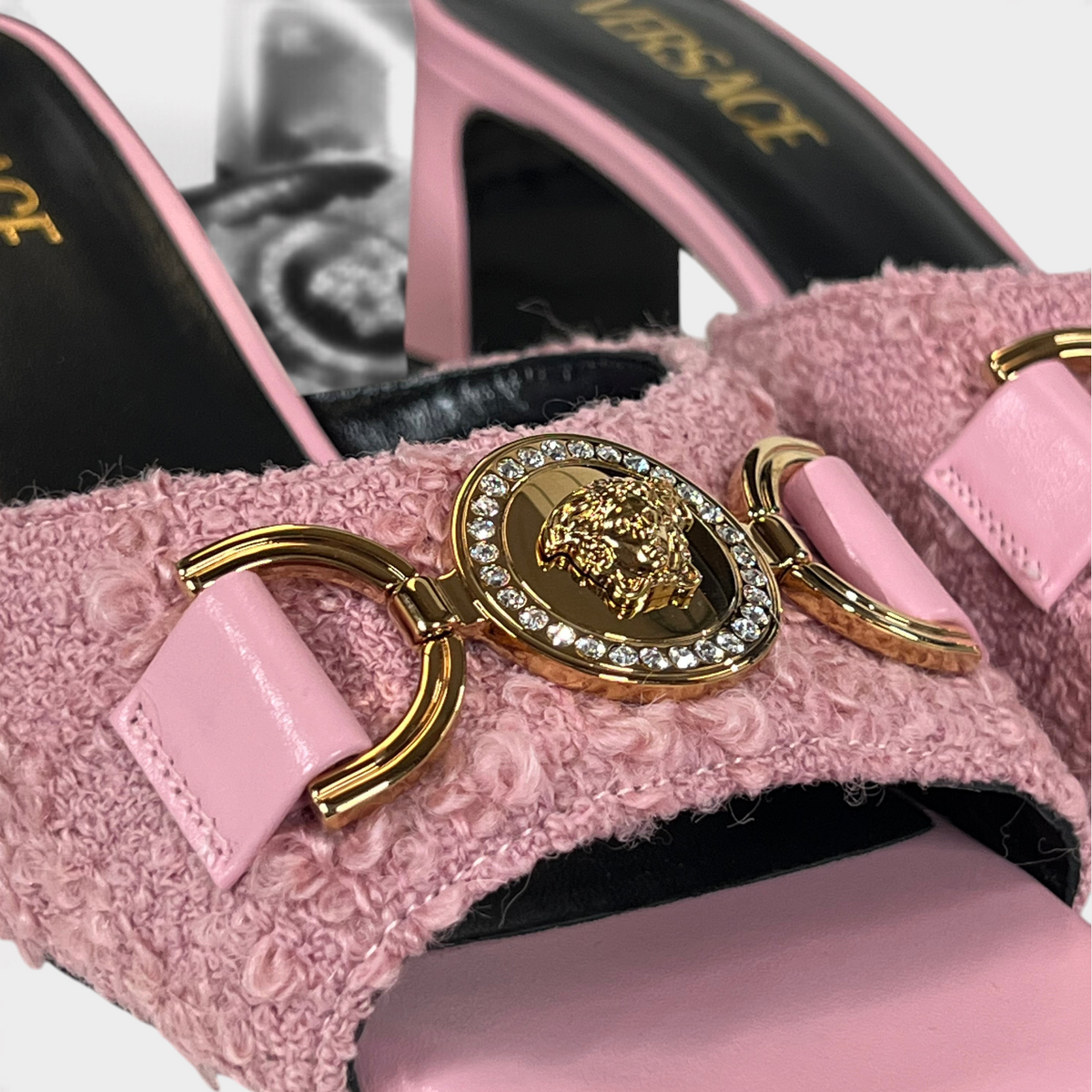 Supplied Fashion pink tweed mule featuring a gold Medusa head emblem with crystal accents and a block heel.