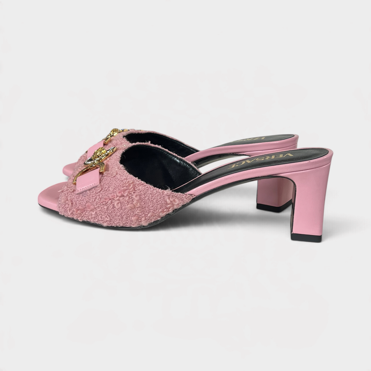 Supplied Fashion pink tweed mules with gold Medusa head hardware and block heels, side view.