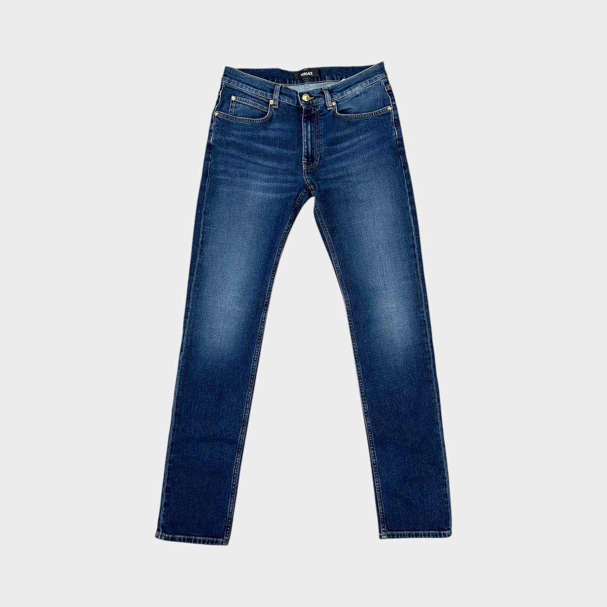 Supplied Fashion Versace Taylor blue denim jeans featuring a signature gold Medusa head button and classic fit.
