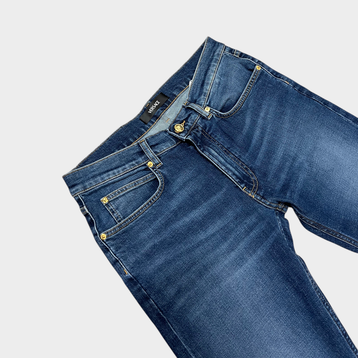 Supplied Fashion Versace blue denim Taylor jeans featuring gold Medusa head button and iconic designer branding