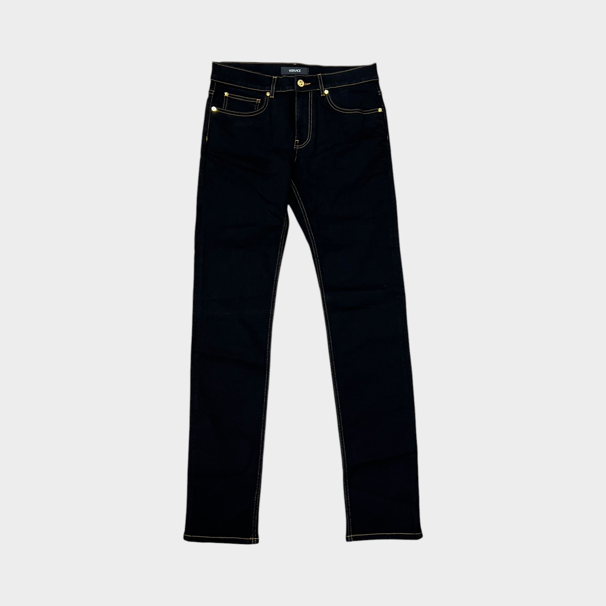 Supplied Fashion black stretch denim jeans with gold Medusa head hardware and contrast stitching.