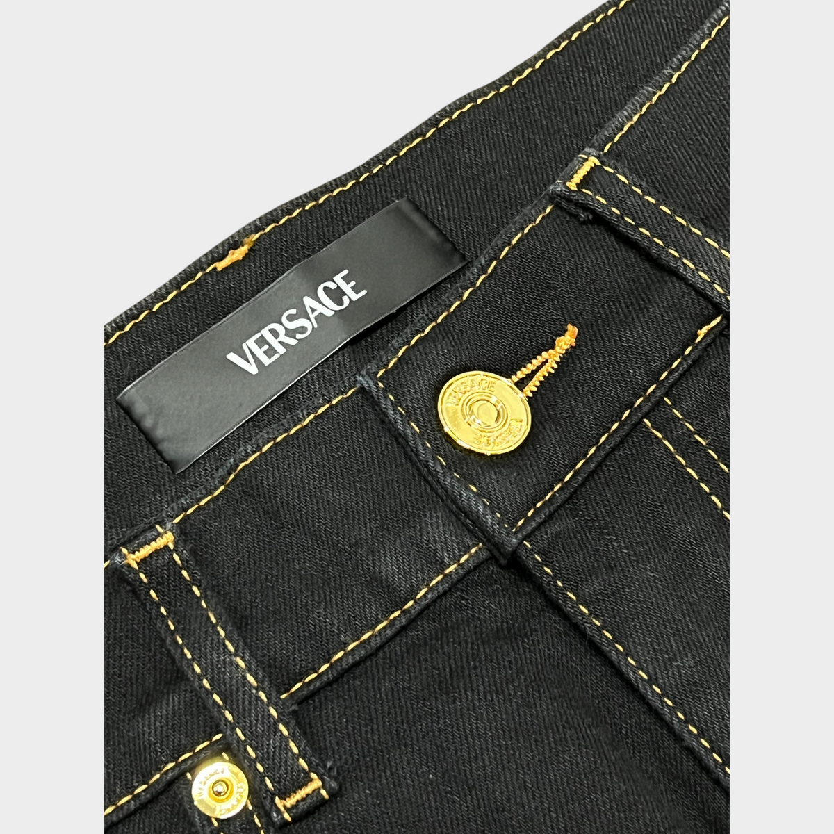 Supplied Fashion black stretch denim jeans with gold Medusa head button and contrast stitching detail