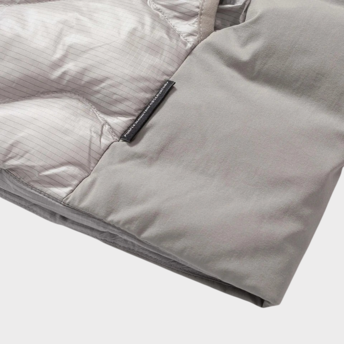 Supplied Fashion Waves Light Puffer in grey featuring grid-patterned lining and Purple Mountain Observatory label.