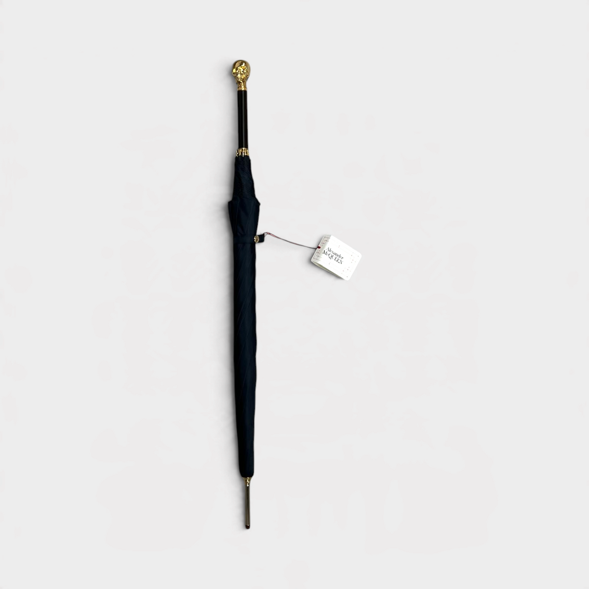 Supplied Fashion Alexander McQueen black umbrella with a gold skull handle and wood detailing