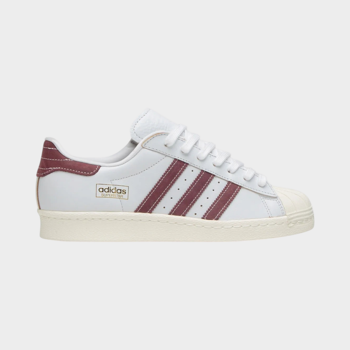 Supplied Fashion Adidas Superstar 80 ADV sneakers in crystal white leather with shadow red stripes and shell toe.