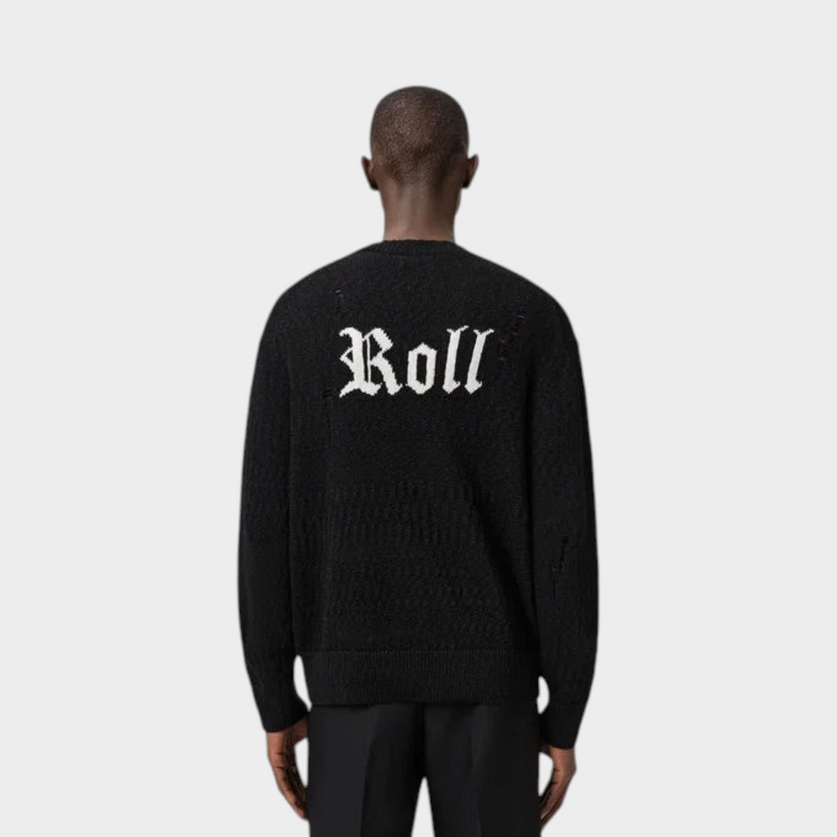 Supplied Fashion black jacquard knit jumper with white Roll text on the back worn by a man from behind