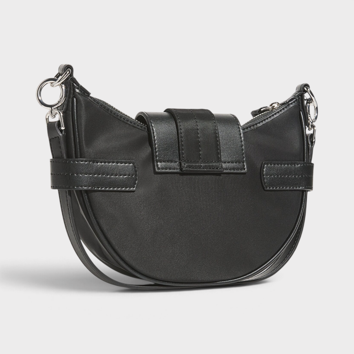 Supplied Fashion Ganni Small Bucky black cross-body bag with a curved silhouette, silver hardware, and buckle detail.