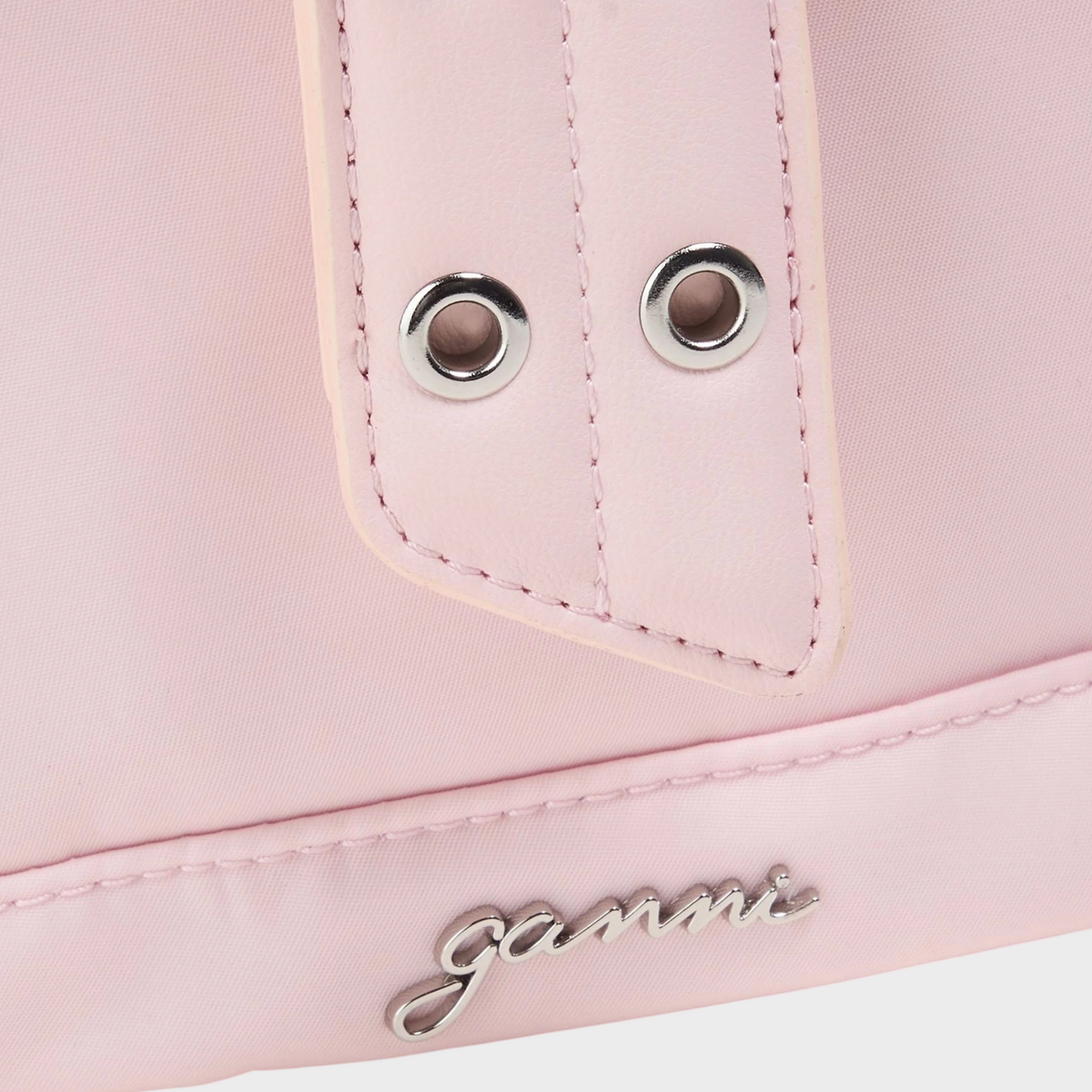 Supplied Fashion Ganni Bucky Shell backpack in chalk pink featuring a silver buckle strap and metallic logo detail.