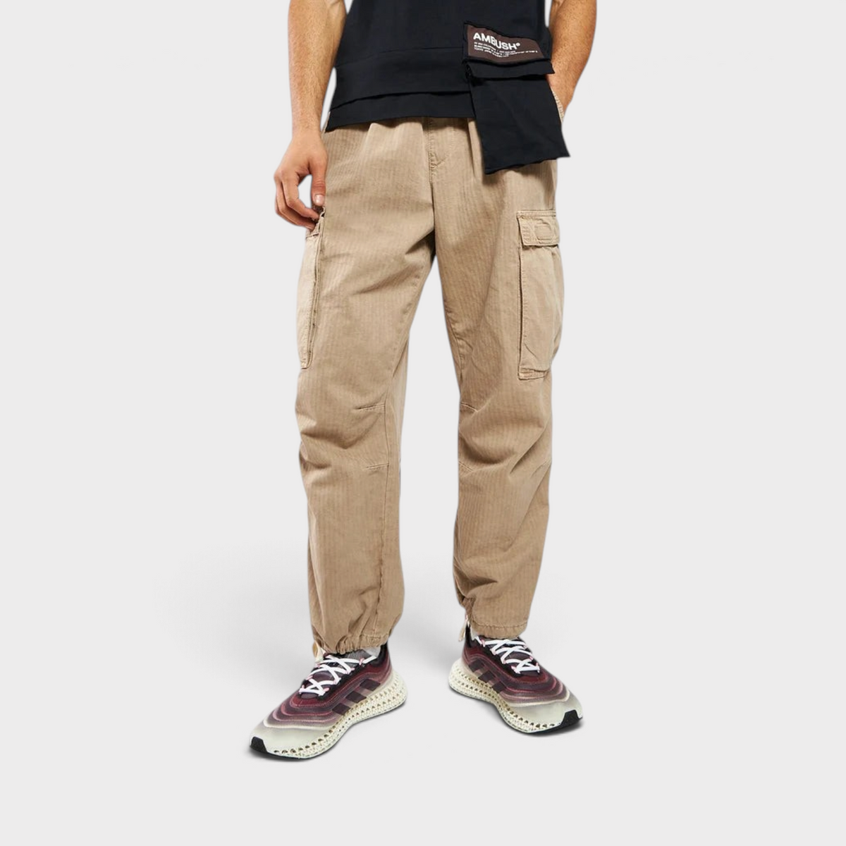 Supplied Fashion model wearing beige corduroy cargo trousers and adidas 4DFWD X Parley running trainers
