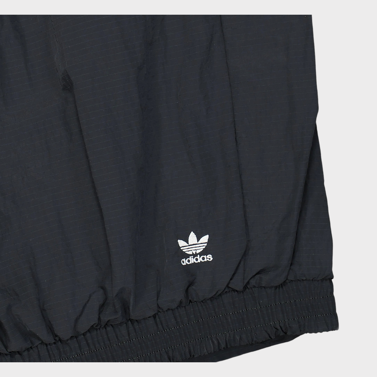Supplied Fashion black adidas Pharrell Williams track jacket with white embroidered trefoil logo and ribbed hem