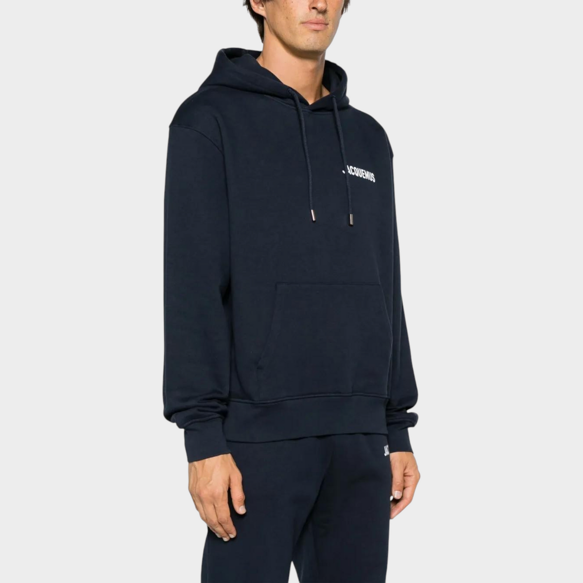 Supplied Fashion dark navy cotton hoodie with white logo print, featuring a drawstring hood and front kangaroo pocket.