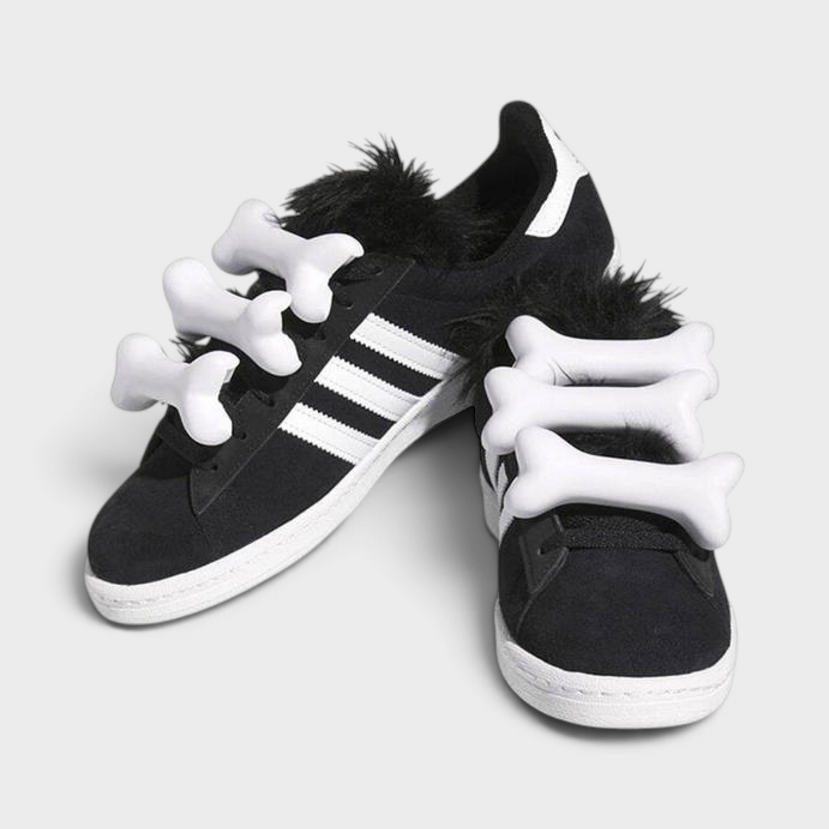 Supplied Fashion Jeremy Scott Campus 80 black suede trainers with white 3D bone attachments and faux fur tongue