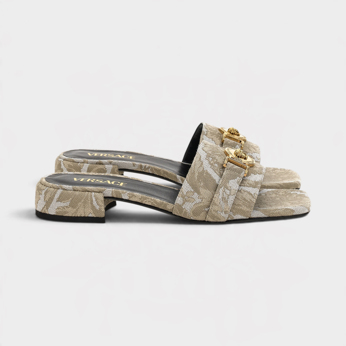 Supplied Fashion beige fabric sandals featuring the iconic gold Medusa head emblem and a low block heel.