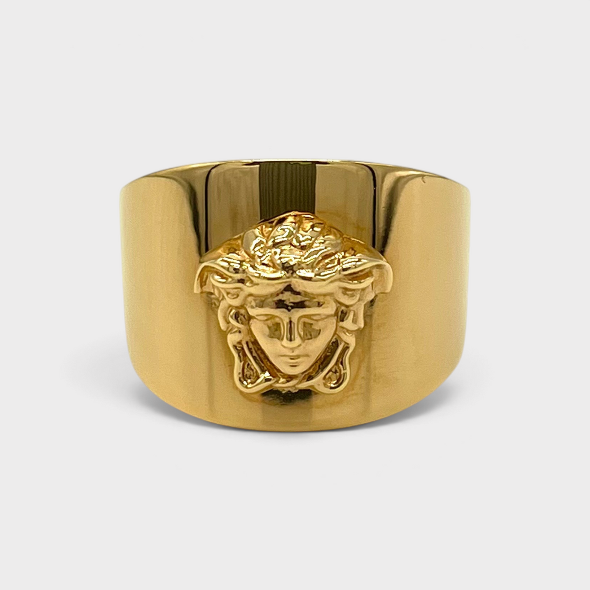 Supplied Fashion gold Medusa head statement ring with a wide band and polished metallic finish.