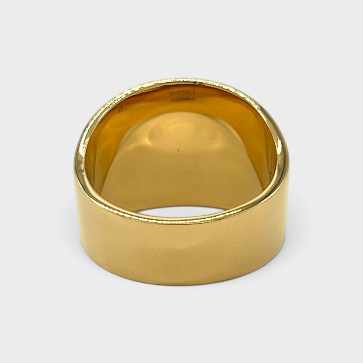 Supplied Fashion gold Medusa head ring with a wide polished band and iconic motif, viewed from the back.