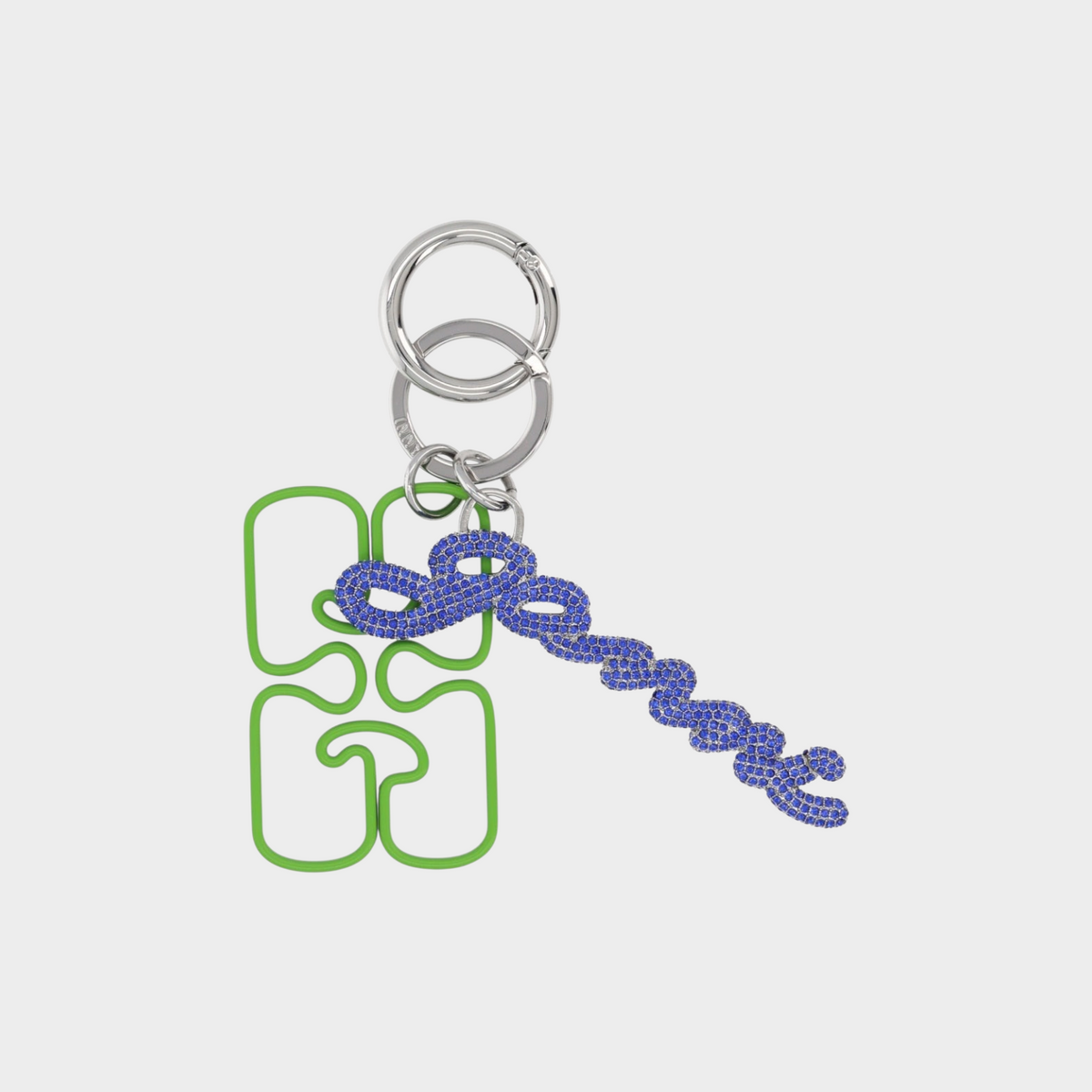 Supplied Fashion Ganni keyring with a green puzzle-shaped charm and a blue crystal-embellished chain detail.