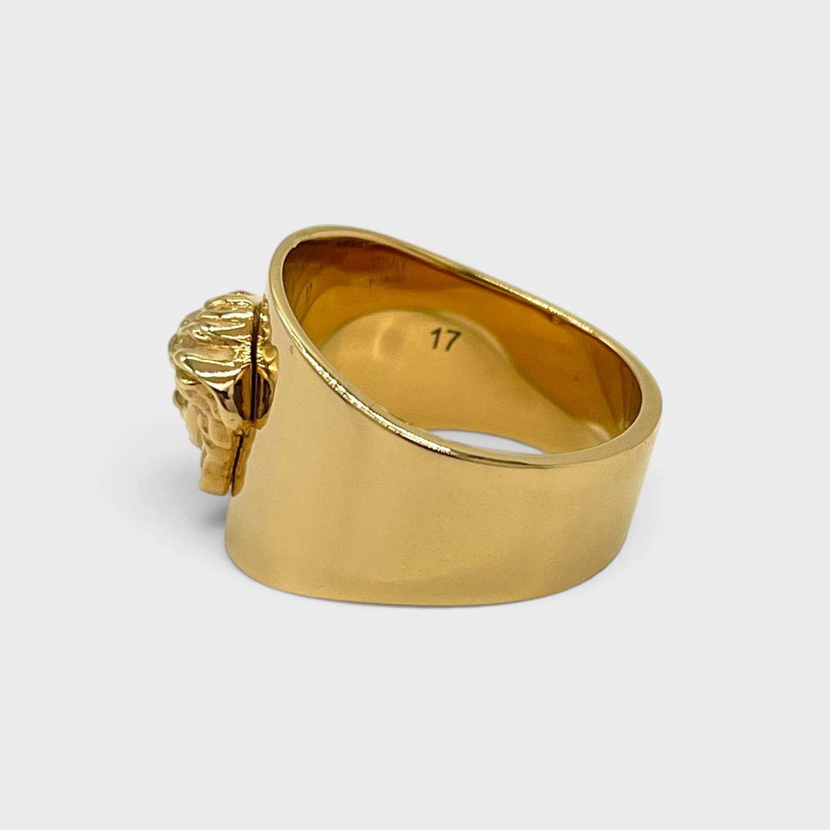 Supplied Fashion gold Medusa head statement ring with a polished finish and engraved size 17 on the inner band