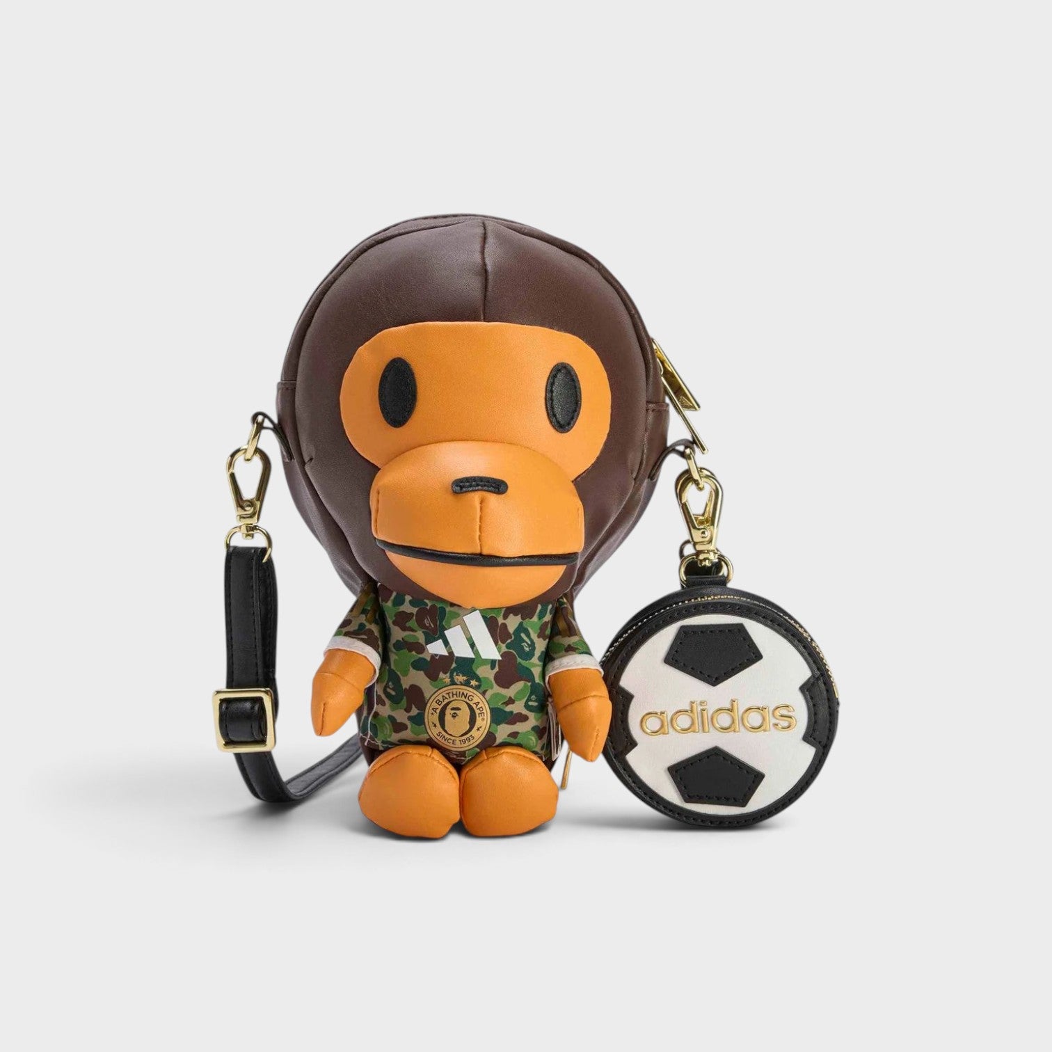 Supplied Fashion adidas x BAPE Baby Milo bag in auburn featuring a camo shirt and a detachable soccer ball coin purse.