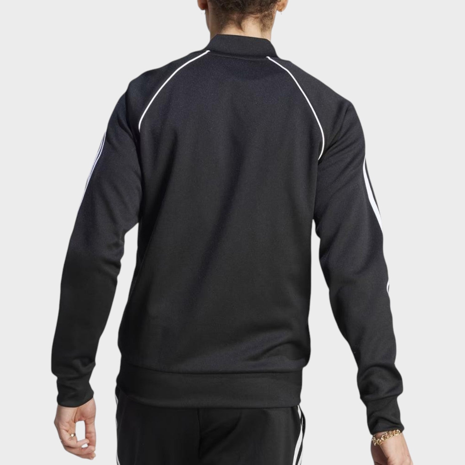 Back view of Supplied Fashion adidas Adicolor Classics Superstar track top in black with white three-stripe detail.