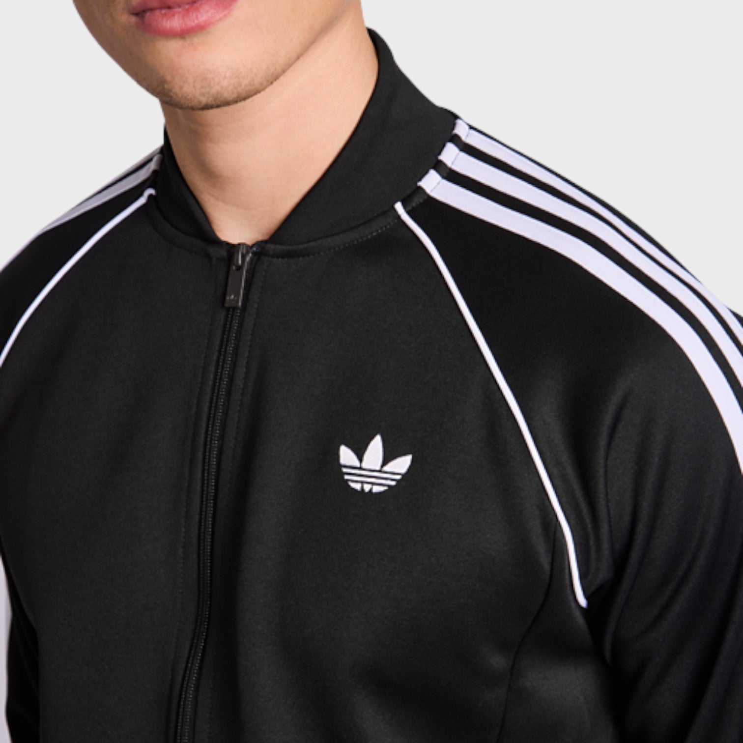 Supplied Fashion adidas Adicolor Classics black track top with white three-stripe detailing and Trefoil logo