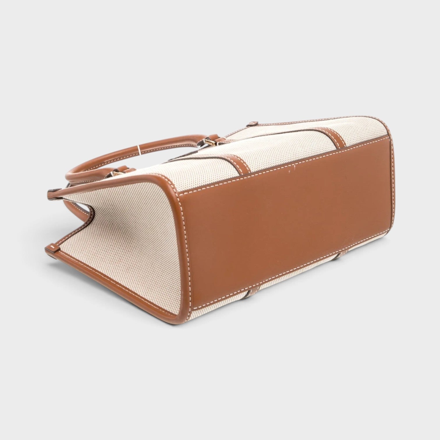 Supplied Fashion beige canvas top-handle bag with brown leather trim and structured base, viewed from below.