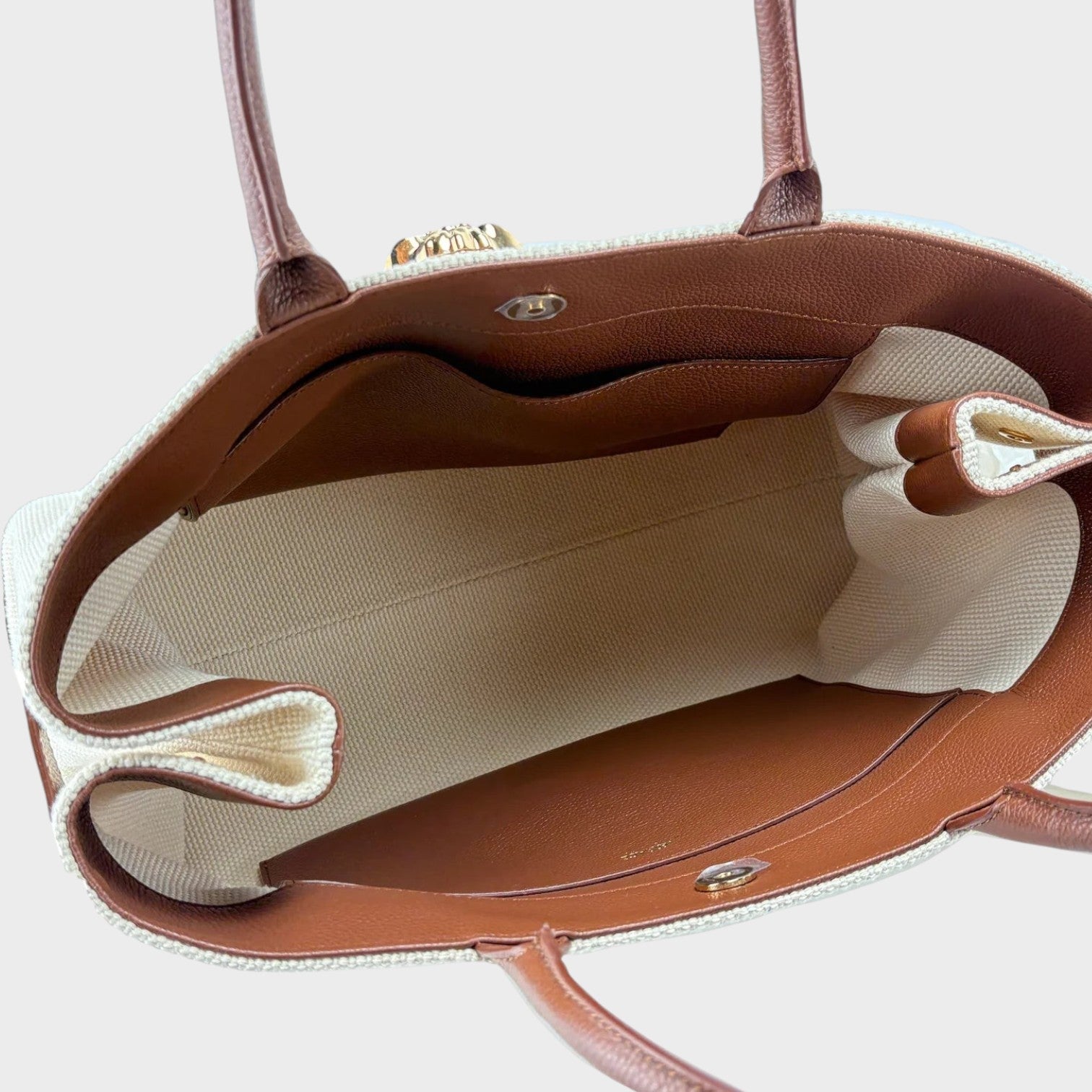 Supplied Fashion beige canvas tote bag with brown leather trim and interior pockets, top-down view