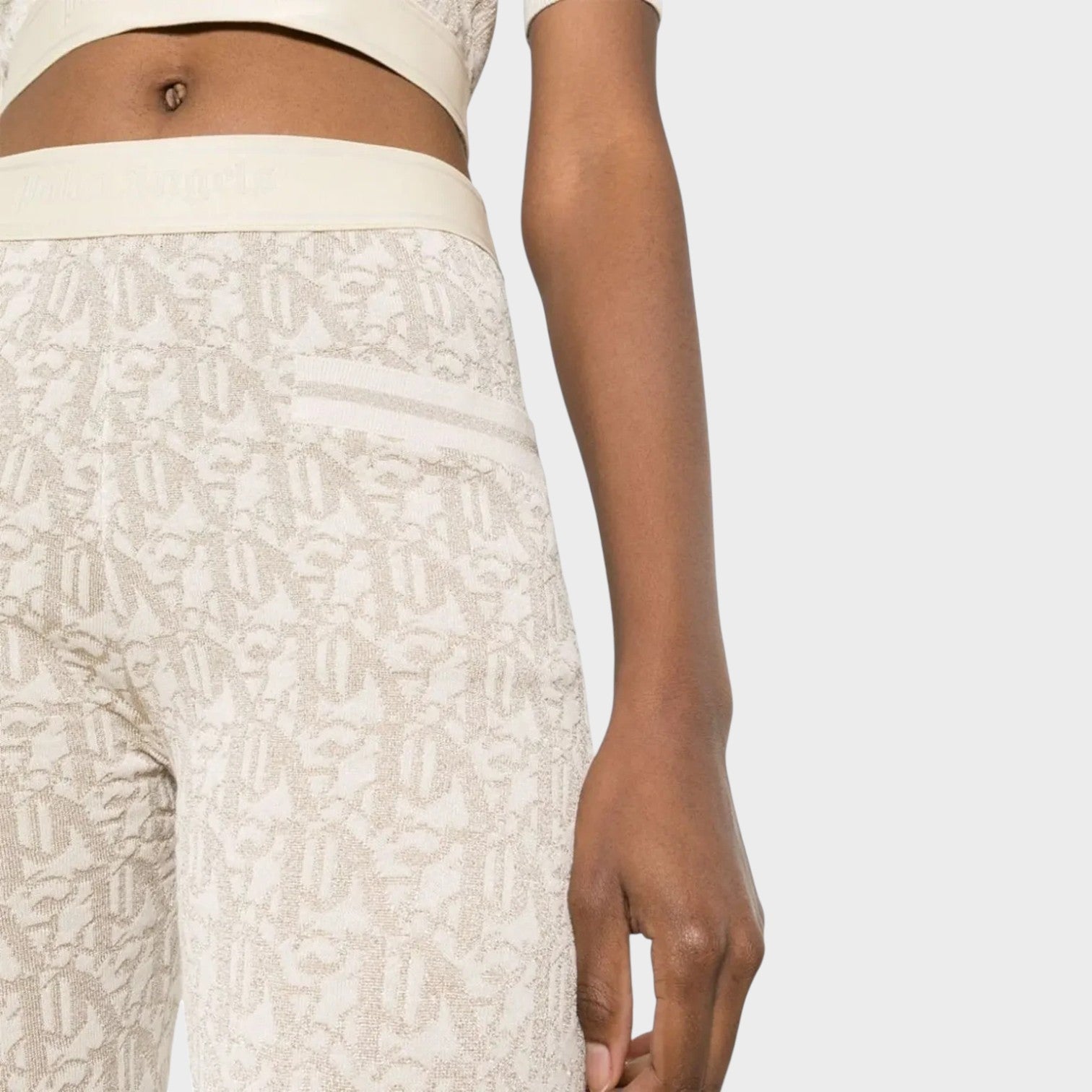 Supplied Fashion beige monogram jacquard knitted trousers with a gold metallic elasticated logo waistband.