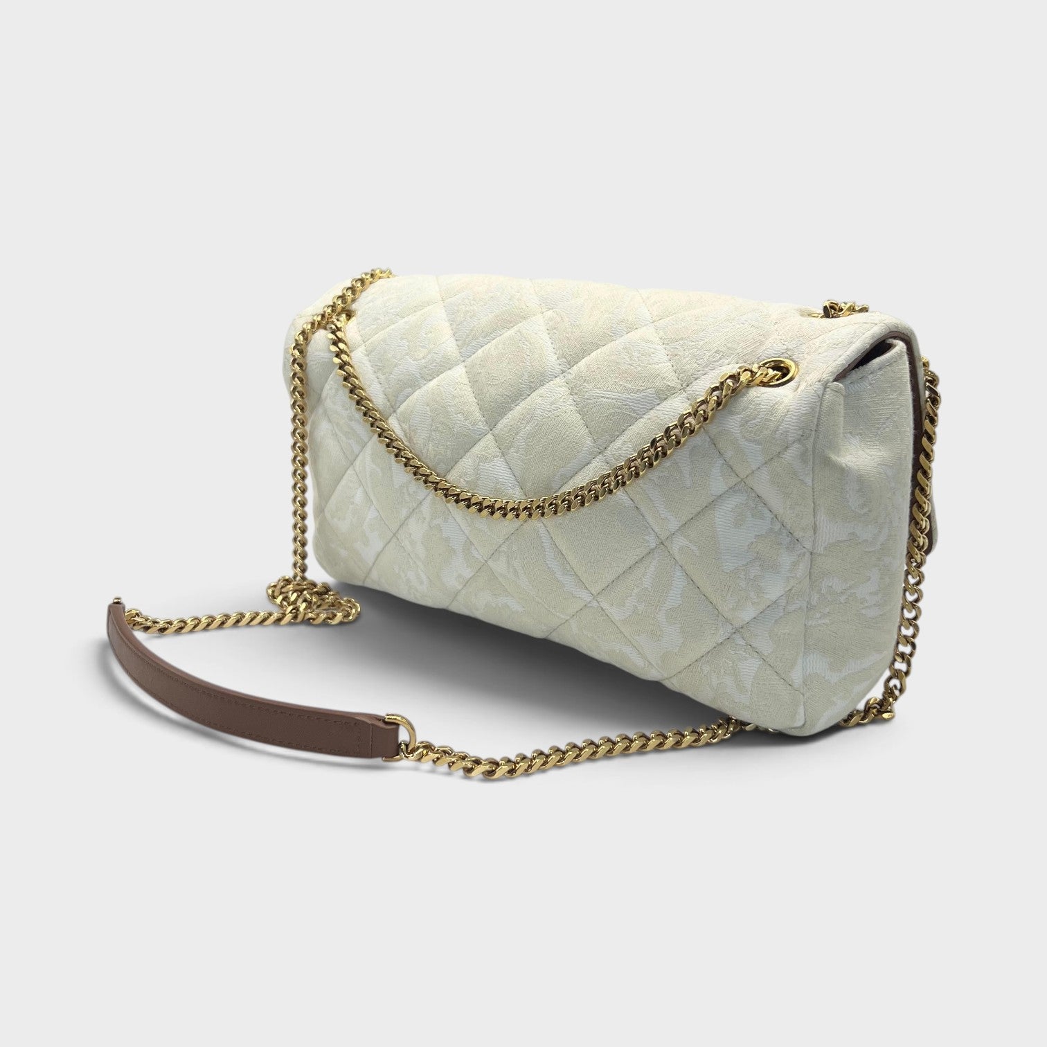 Supplied Fashion beige quilted shoulder bag with gold chain strap and Medusa head motif in a structured silhouette.