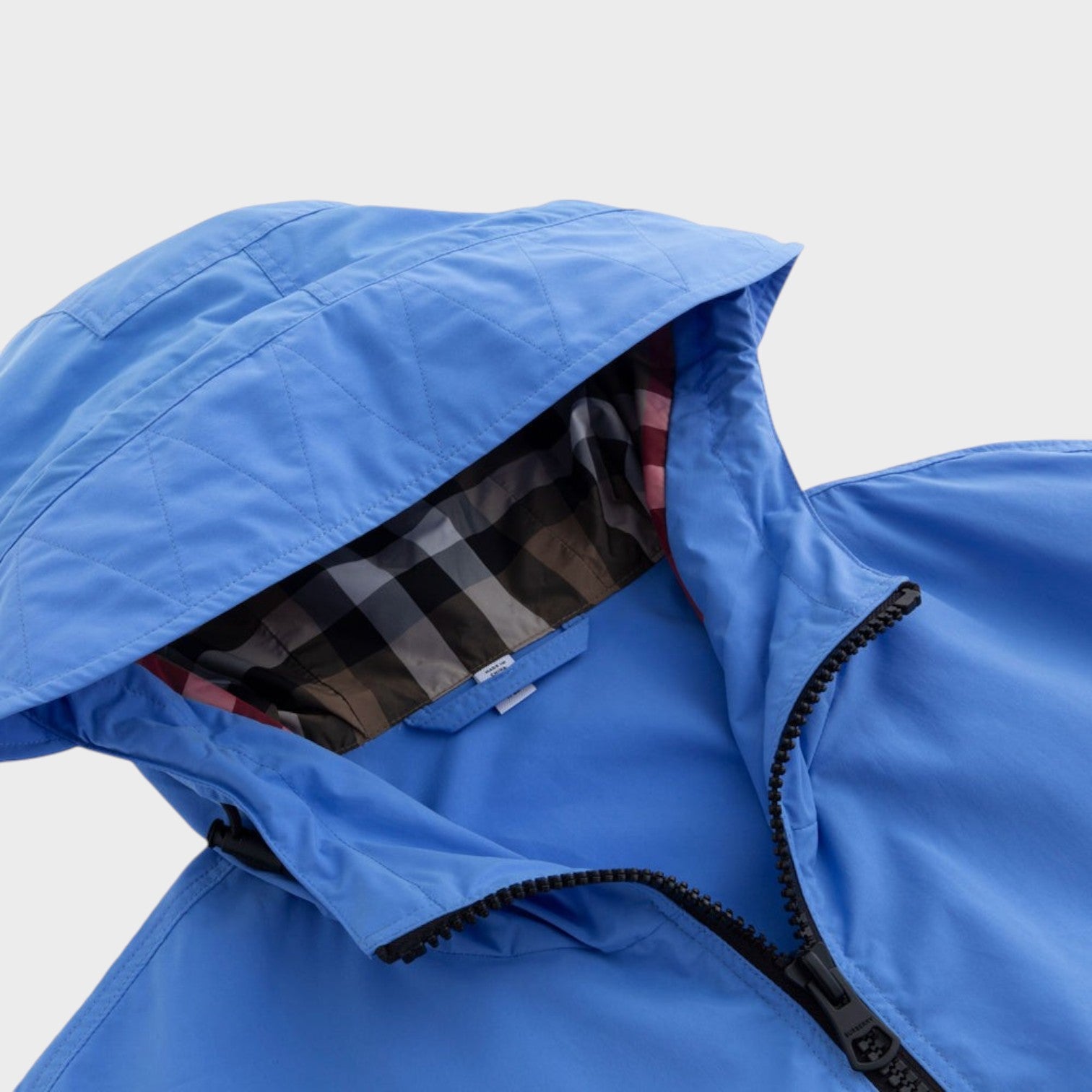 Supplied Fashion Birley long blue jacket featuring a hooded design with signature check lining and zip closure