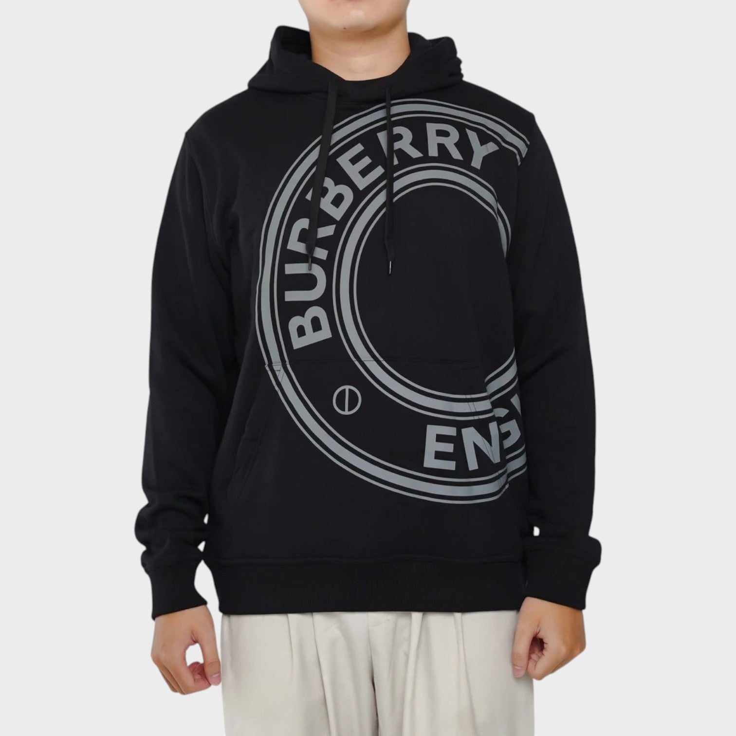 Supplied Fashion black Burberry Farley hoodie featuring a large circular logo print on the chest and a drawstring hood.