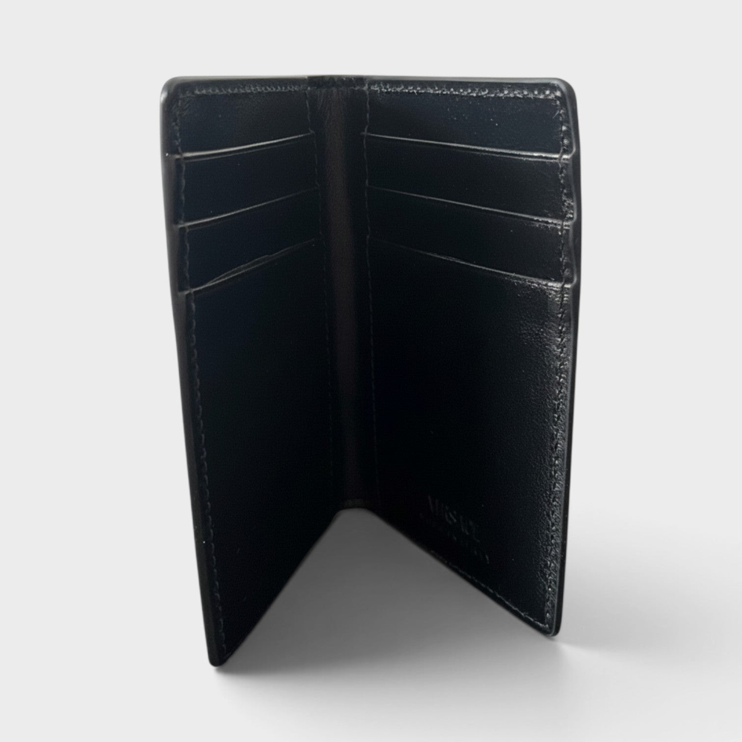 Supplied Fashion black leather card case with multiple slots and a minimalist structured design.